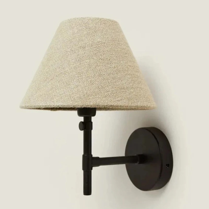 Japandi tapered cone wall light with beige shade, black arm, and round wall plate