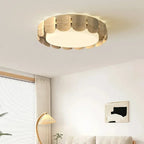 Ceiling light with rounded scalloped wood panels and evenly lit frosted center