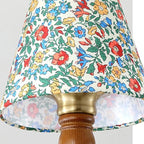 Floral fabric lampshade with gold-toned collar and scalloped trim