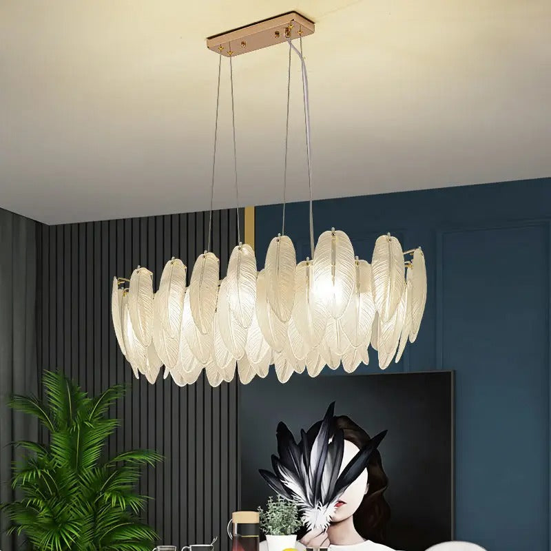 Feather-glass chandelier with white leaf shades and gold finials, hanging on long cords