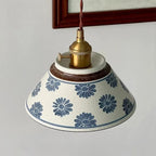 Ceramic conical pendant light with blue and brown stripe pattern shade underside