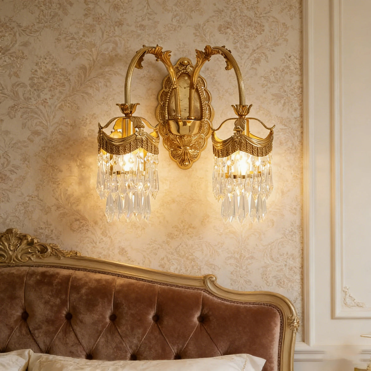 Gold crystal wall sconce with curved arms and two hanging glass shade clusters
