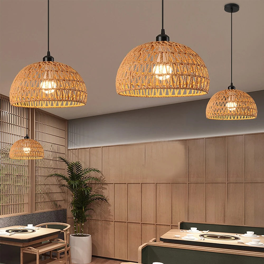 Set of three rope-woven trapezoid pendant lights with black canopies and glowing bulbs