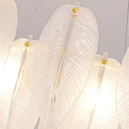 Close-up of white feather glass shades with gold-capped stems on a hanging chandelier
