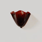 Red scalloped wave glass wall light with black mounting cap and single bulb base