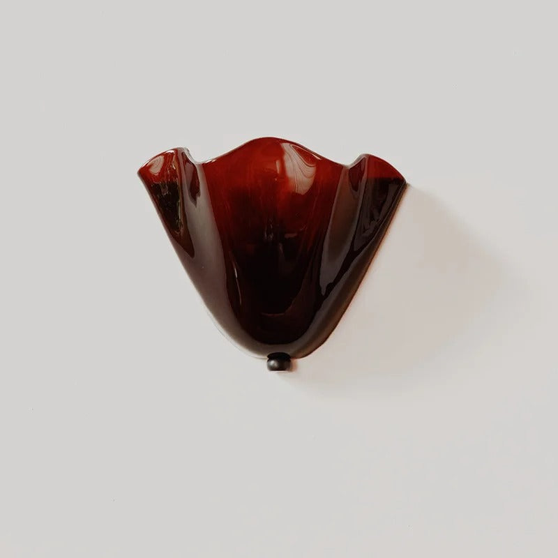 Red scalloped wave glass wall light with black mounting cap and single bulb base