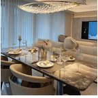 Boat-shaped crystal chandelier with gold frame and hanging clear prisms