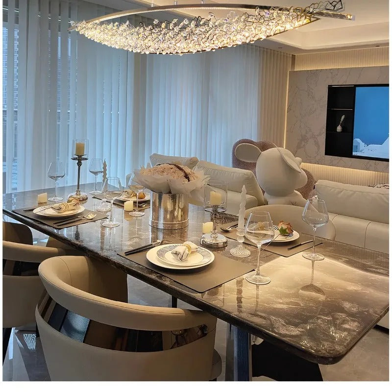 Boat-shaped crystal chandelier with gold frame and hanging clear prisms