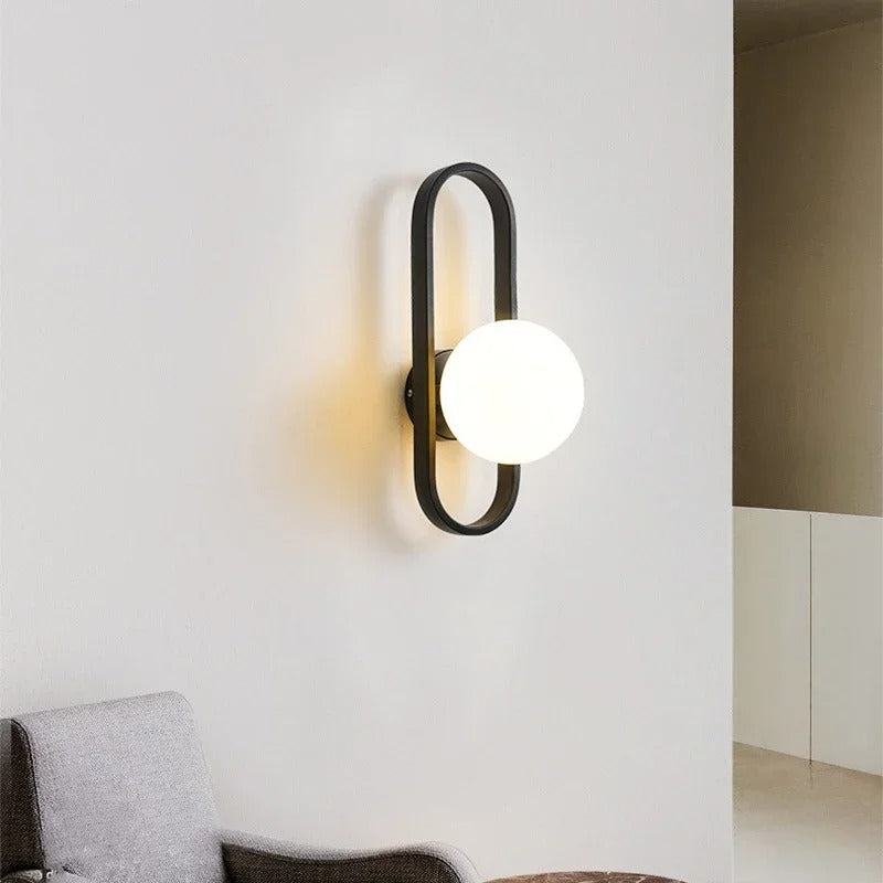Black oval ring globe wall light with round white glass shade