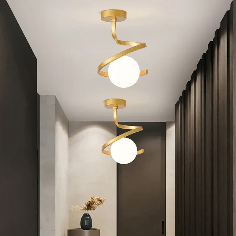 Gold spiral ceiling light with two white globe shades and circular mounting plate.