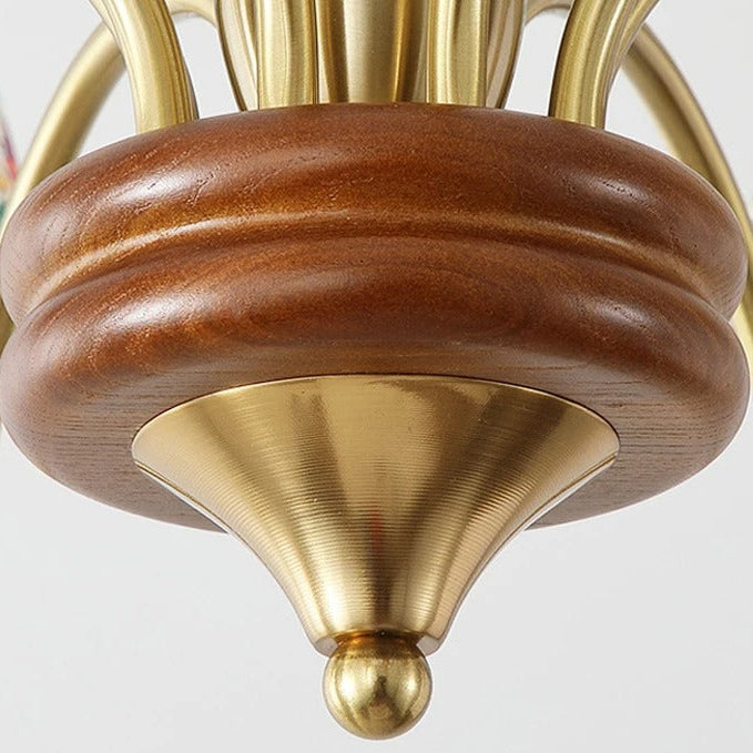Gold-tone finial on turned wood chandelier stem with brass cap
