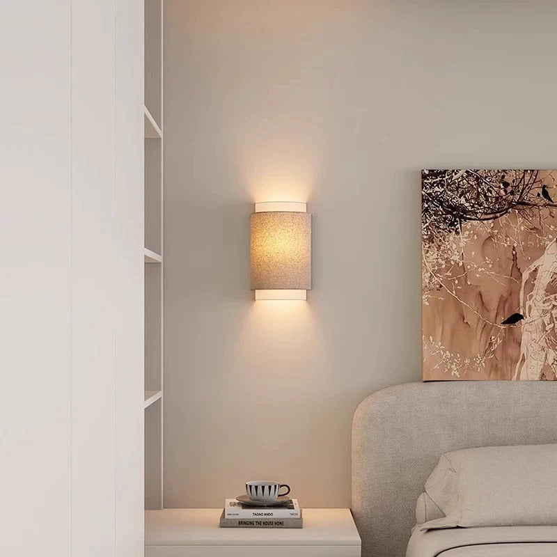 Beige fabric D-shaped wall light with warm light from textured fabric shade