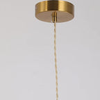 Brass pendant light ceiling cap with twisted cord hanging down