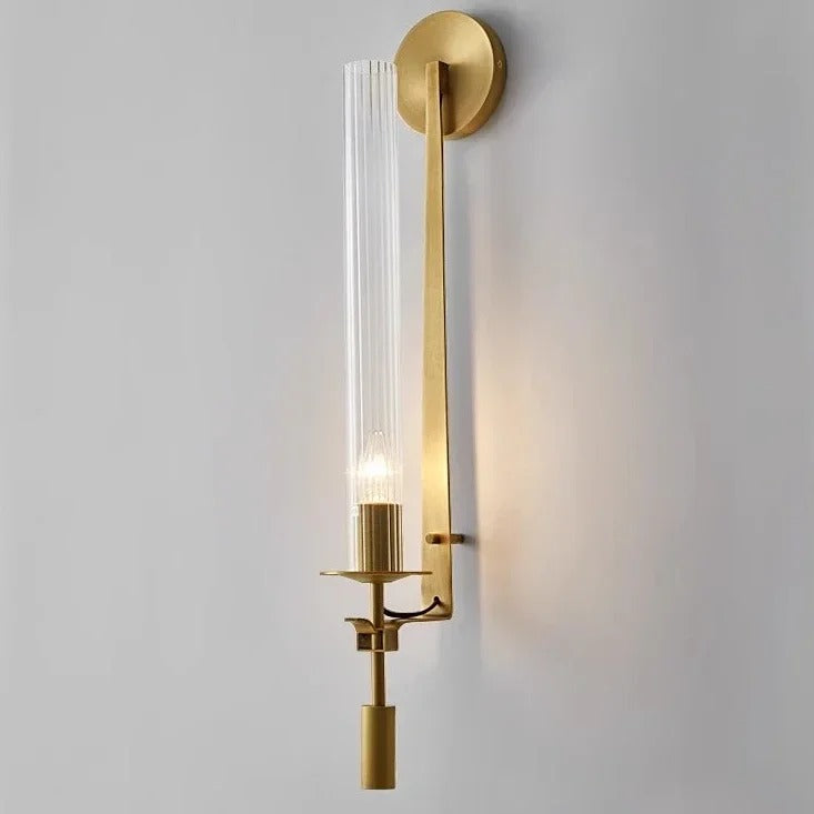 Gold wall light with vertical cylindrical glass tube and round backplate