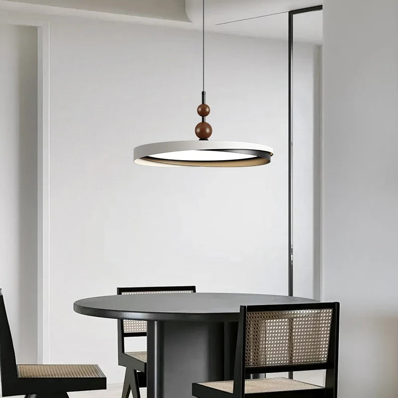 Ring LED disc pendant light with dark canopy, circular shade, and three wooden beads on cord