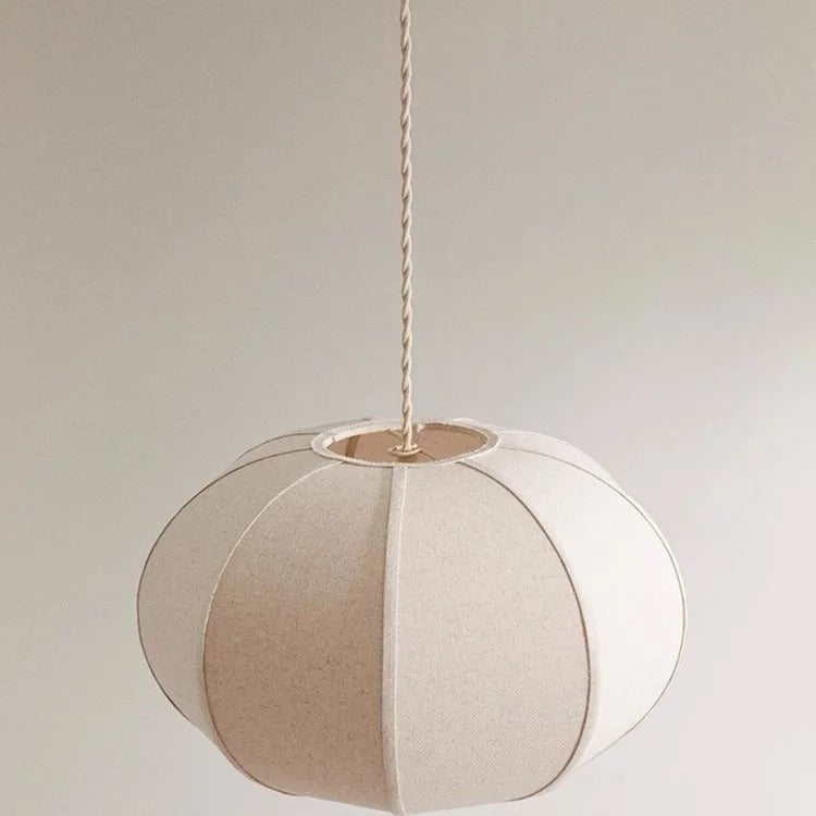 Segmented circular pendant light with light cream and tan panels, hanging cord and canopy