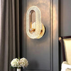 Gold textured oval wall light sconce with brass ring and warm illumination