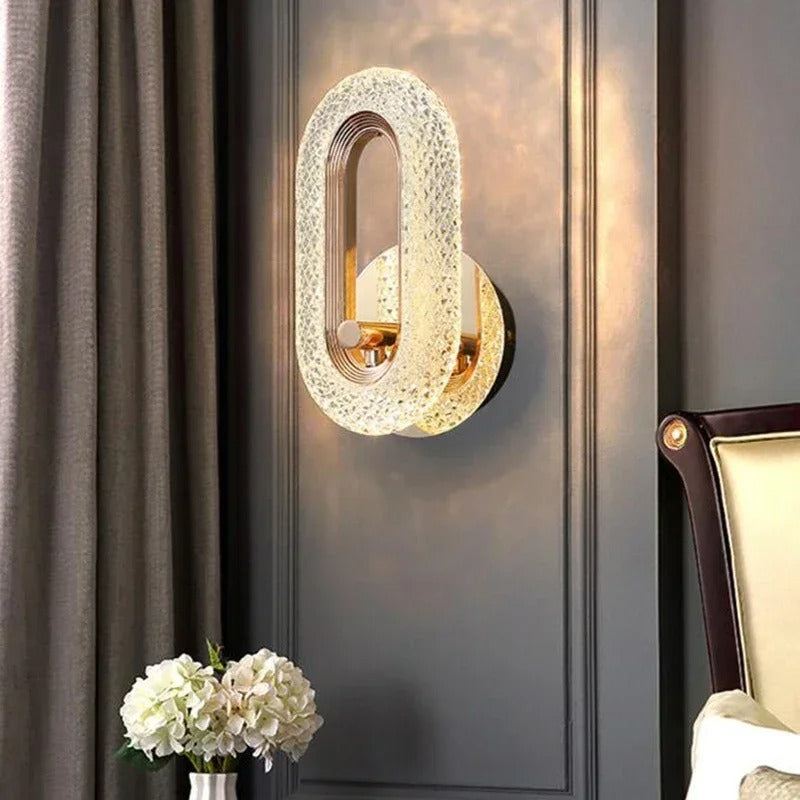 Gold textured oval wall light sconce with brass ring and warm illumination