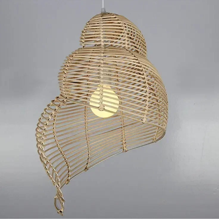 Woven rattan spiral shell pendant light with capped shade and warm bulb glow