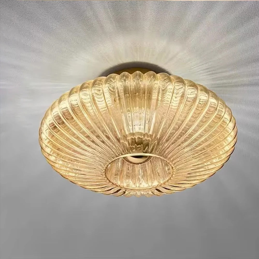 Amber fluted saucer ceiling light close-up with ribbed glass shade and recessed ring opening