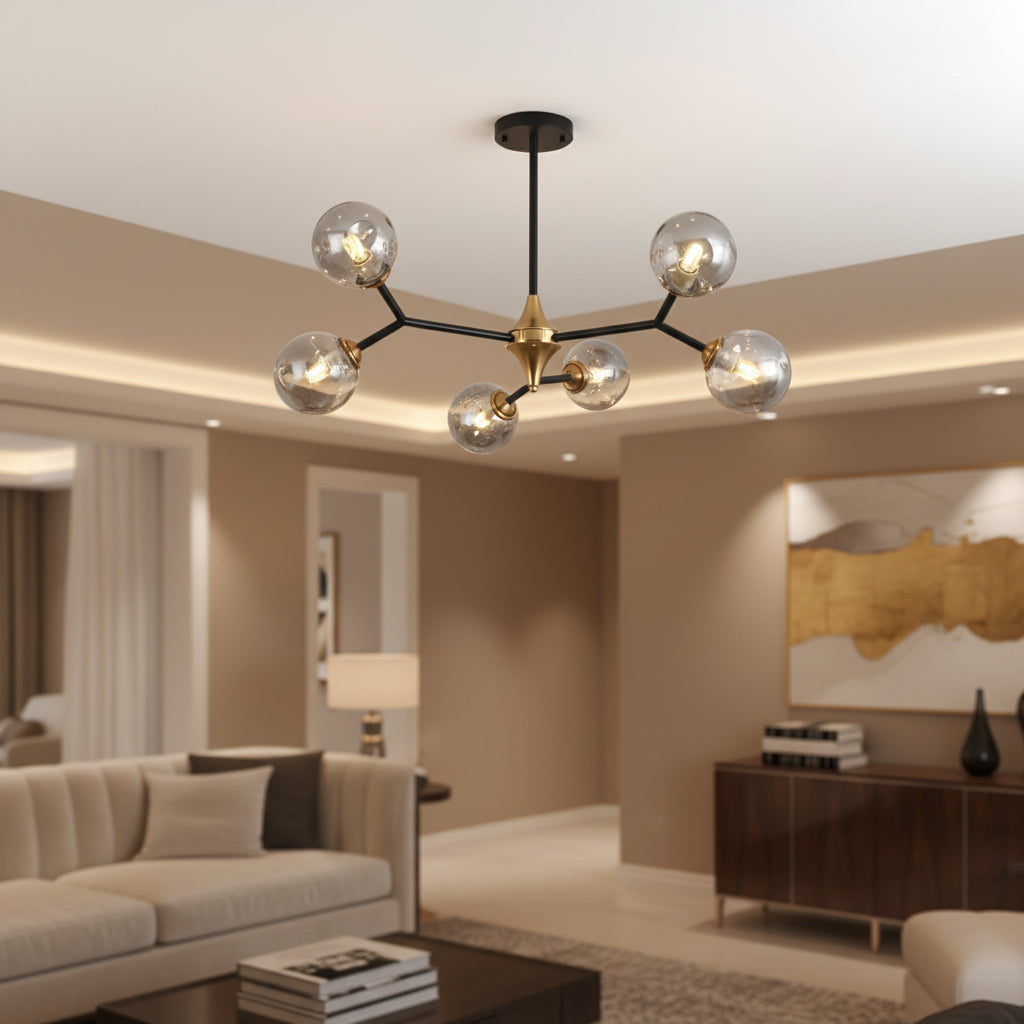 Bubble orb ceiling chandelier with five glass globes, black frame, and gold center mount