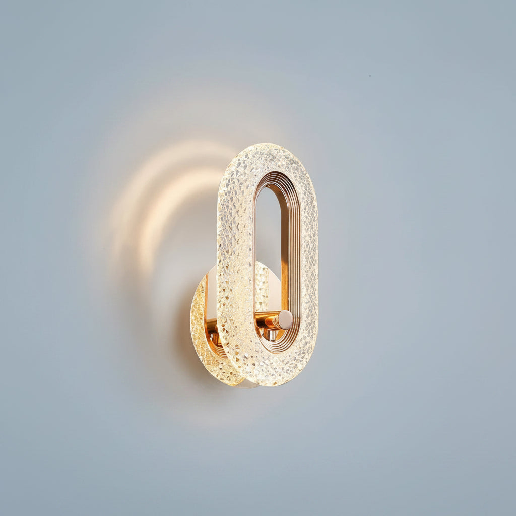 Gold oval wall light sconce casting a circular glow on the wall