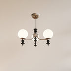 Multi-arm globe chandelier with three white globe shades and a bronze central stem
