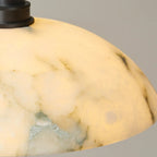Alabaster domed shade with marble veining, warm-lit pendant lamp