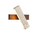 Long bar wall sconce with speckled travertine front and warm linear LED light