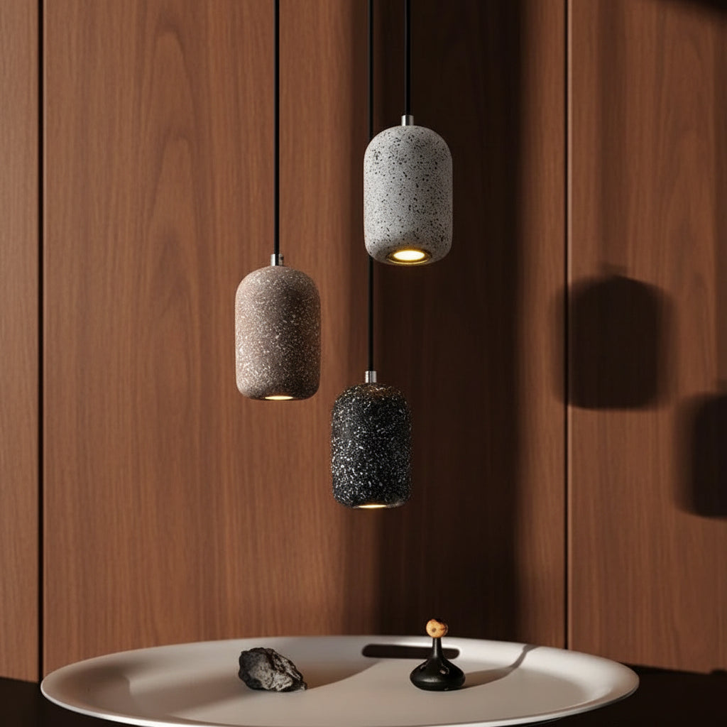 Concrete cylindrical pendant light cluster with speckled gray and black shades and black cords