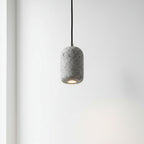 Concrete cylindrical pendant light with speckled gray shade and black cord