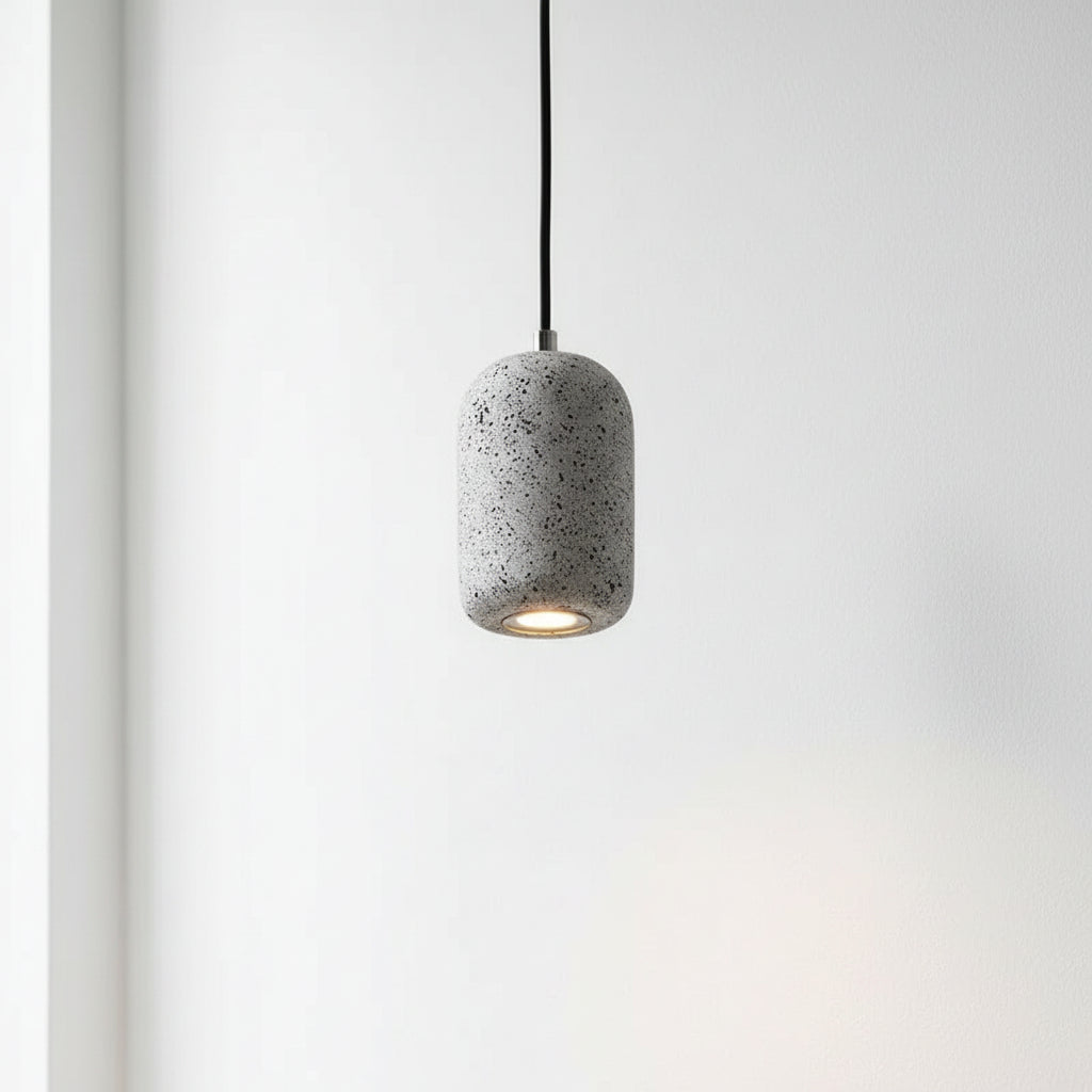 Concrete cylindrical pendant light with speckled gray shade and black cord