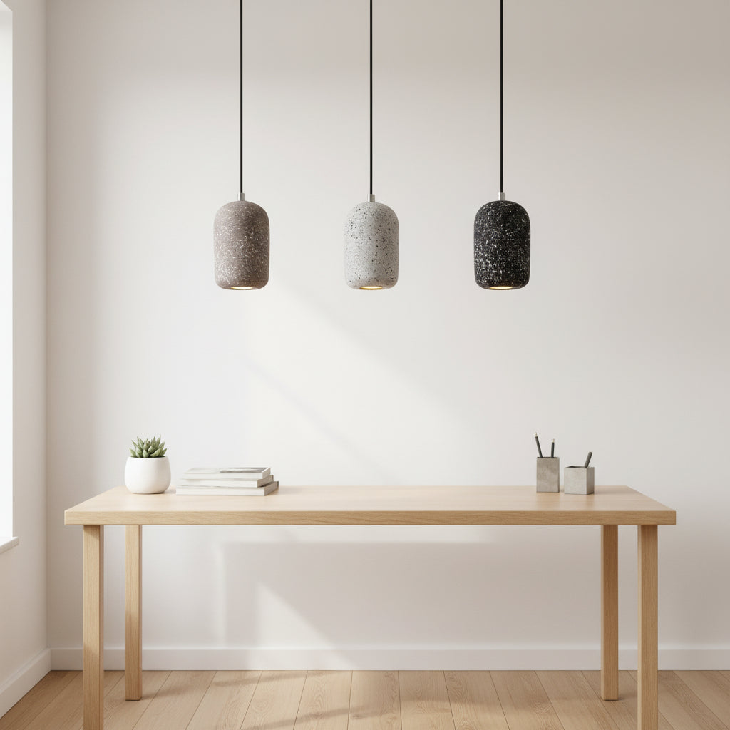 Concrete cylindrical pendant light set with speckled gray and black shades and black cords