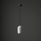 Concrete cylindrical pendant light with speckled light-gray shade and black ceiling mount