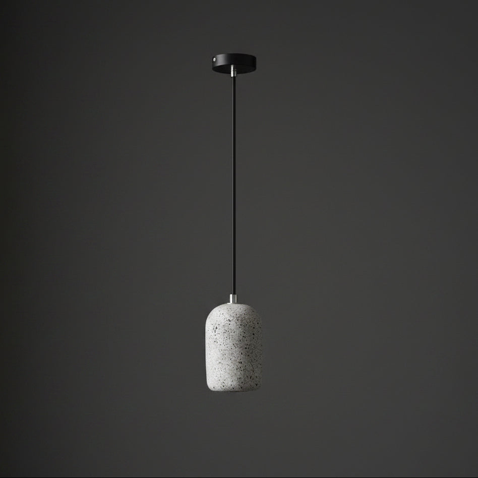 Concrete cylindrical pendant light with speckled light-gray shade and black ceiling mount