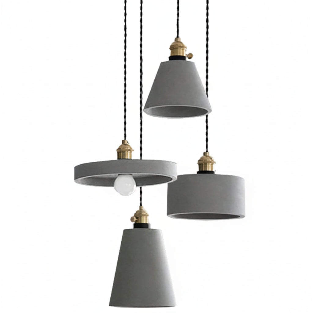 Concrete pendant light with three gray cylindrical shades and brass sockets on cords