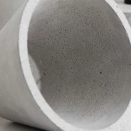 Concrete pendant light shade close-up with speckled gray texture and white rim