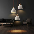Ribbed dome pendant lights with textured cream shades and brown cords, multiple hanging lamps