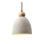 Ribbed dome pendant light with cream textured shade and brown cord, close-up