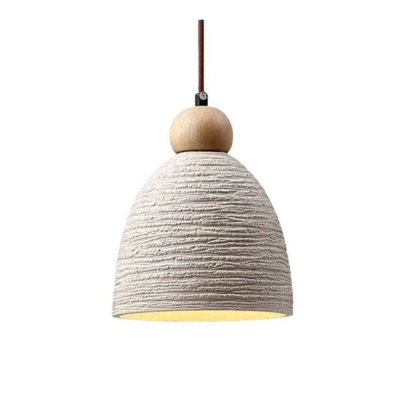 Ribbed dome pendant light with cream textured shade and brown cord, close-up