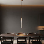 Fluted cone pendant light with light wood canopy and textured cone shade on cord