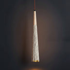 Fluted cone pendant light with light wood canopy and tassel trim on textured shade