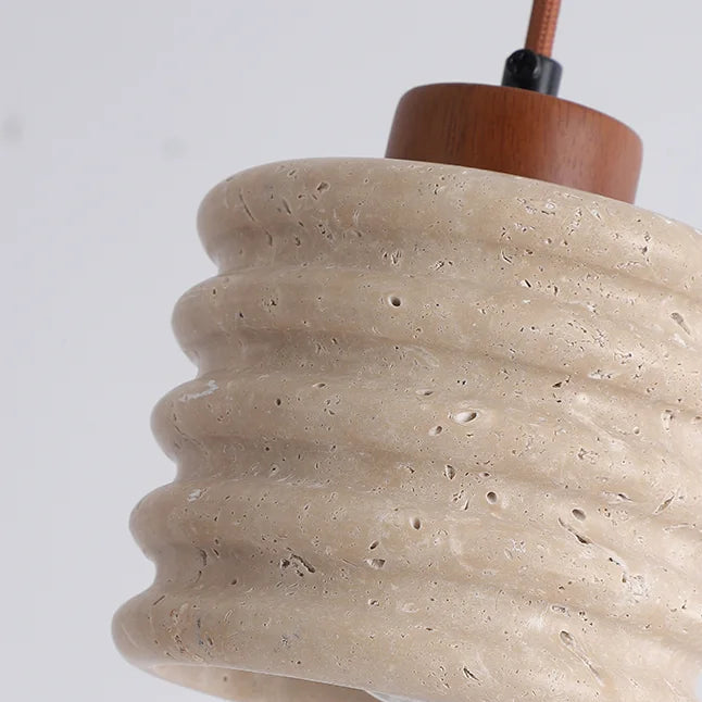 Close-up travertine pendant shade with ribbed stacked rings and natural speckling