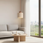 Ribbed travertine pendant light with cylindrical shade and visible warm light