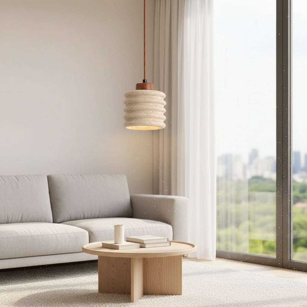 Ribbed travertine pendant light with cylindrical shade and visible warm light