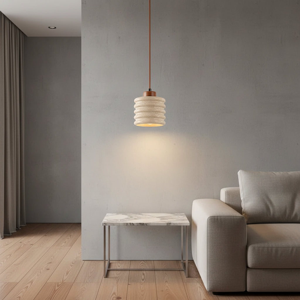 Ribbed travertine pendant light with warm-lit cylindrical travertine shade