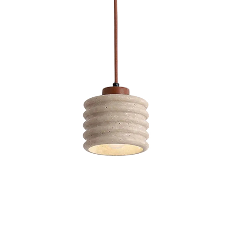 Cylindrical travertine pendant light with ribbed shade and warm glow