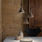 Conical concrete pendant lights, speckled gray shades with black cord and canopy