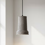 White terrazzo stepped cone pendant light with flared bottom and black cord