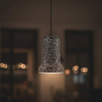 Black terrazzo stepped cone pendant light with black cord and wide bottom
